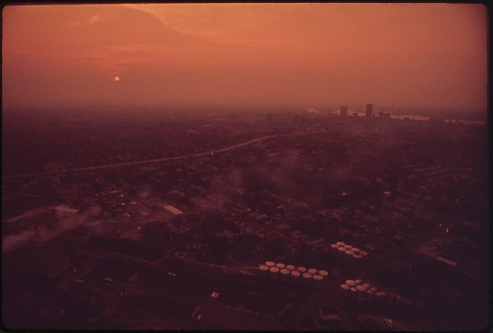 A city skyline obscured by a layer of air pollution