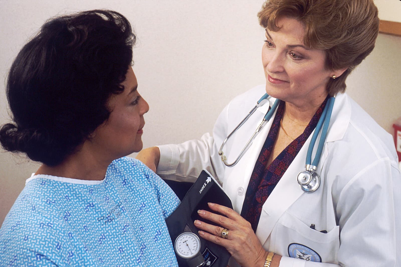 A doctor measuring a patient's blood pressure during a clinic visit